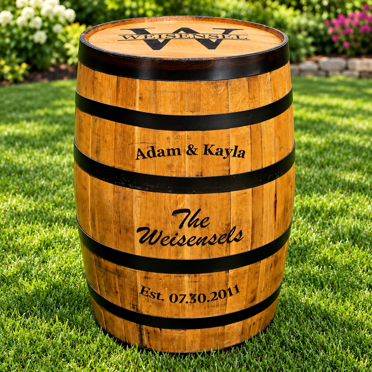 Personalized whiskey barrel engraved with Adam and Kayla's names, the Weisensel family name, and established date
