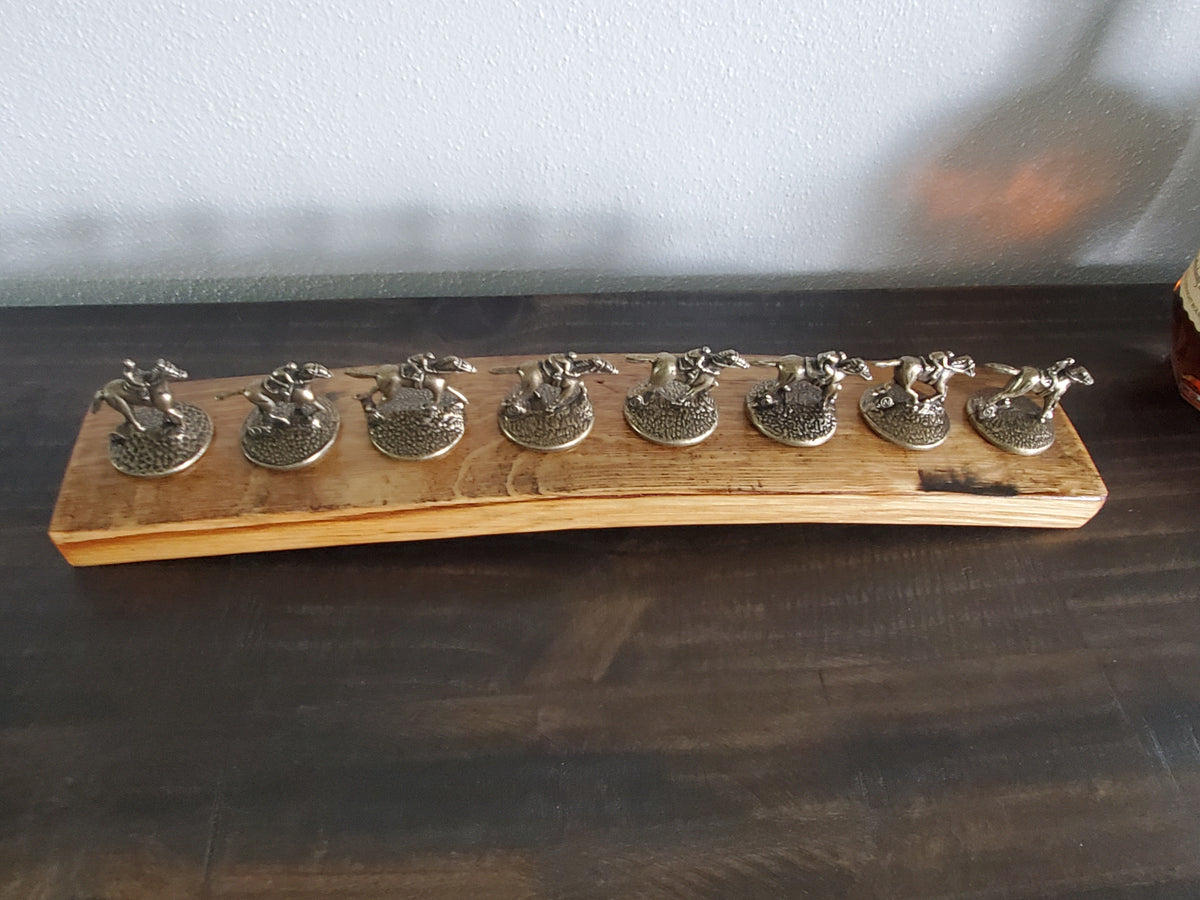Top view of eight bottle stopper positions on a handcrafted bourbon barrel stave display.