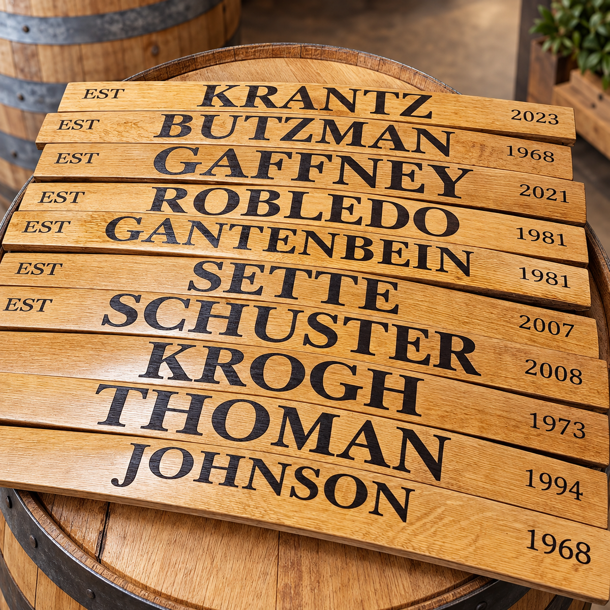 Wooden barrel stave signs engraved with family names and established years