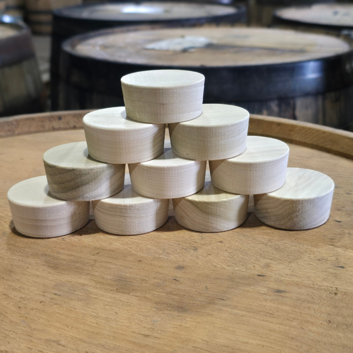 Poplar barrel bung plugs stacked on a whiskey barrel