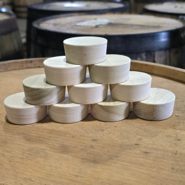 Poplar barrel bung plugs stacked on a whiskey barrel