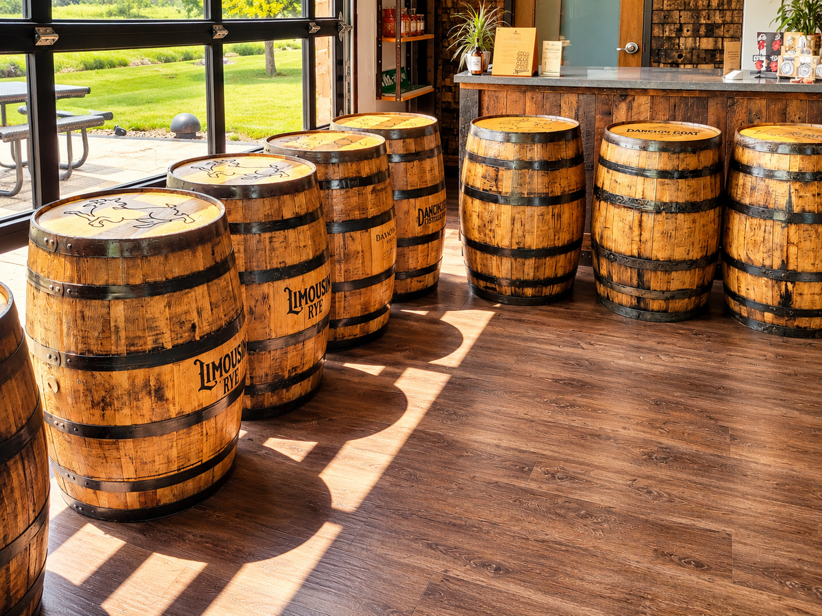 Rows of branded whiskey barrels displayed inside a distillery